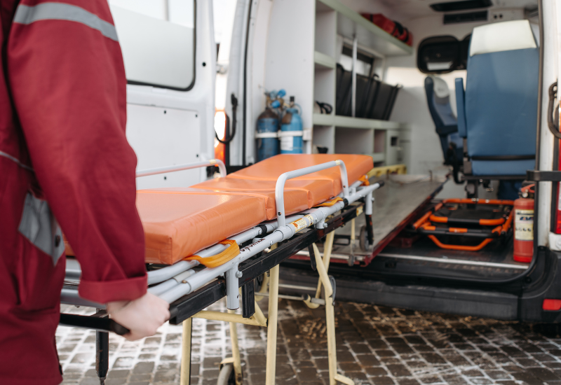 Stretcher with an orange mattress being checked out